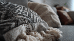 Close-Up of Cozy Textured Throw Pillows on a Neutral Sofa