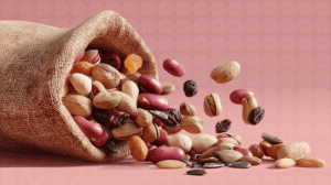 Assorted Mixed Nuts and Seeds Spilling from Burlap Sack
