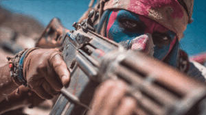 Painted Warrior Aiming Rifle in Desert Wasteland