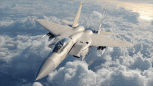 Light Grey Military Jet Flying Over Clouds at Sunset