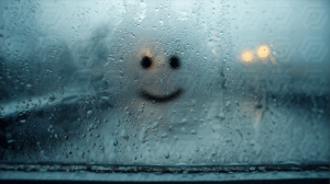 Smiley Face on a Foggy Window During Rain