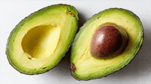 Halved Avocados Displayed on Clean White Surface
