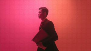 Business Professional in Vibrant Red Light Holding Portfolio