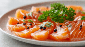 Salmon Sashimi Plate with Black Pepper and Leafy Garnish