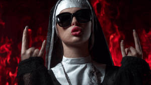 Glamorous Nun with Rock Gesture in Fiery Backdrop