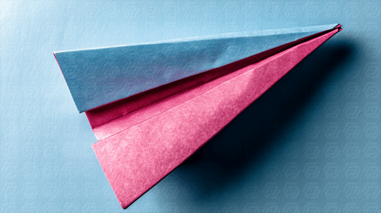 Blue And Pink Origami Plane On Textured Surface