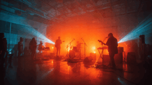 Crowd and Band in Intimate Live Concert With Colored Beams