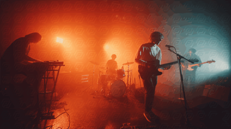 Indie Band Performing Live in Warm Red Stage Lighting