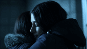 Women Comforting Each Other In Cold Blue Light