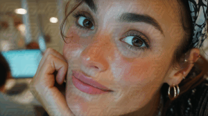Smiling Woman With Freckles in Modern Office Setting